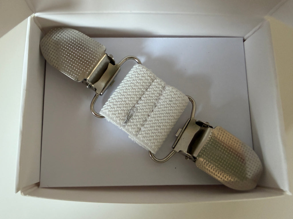 CapeAble - Silberner Clip mit weissem Elastik.